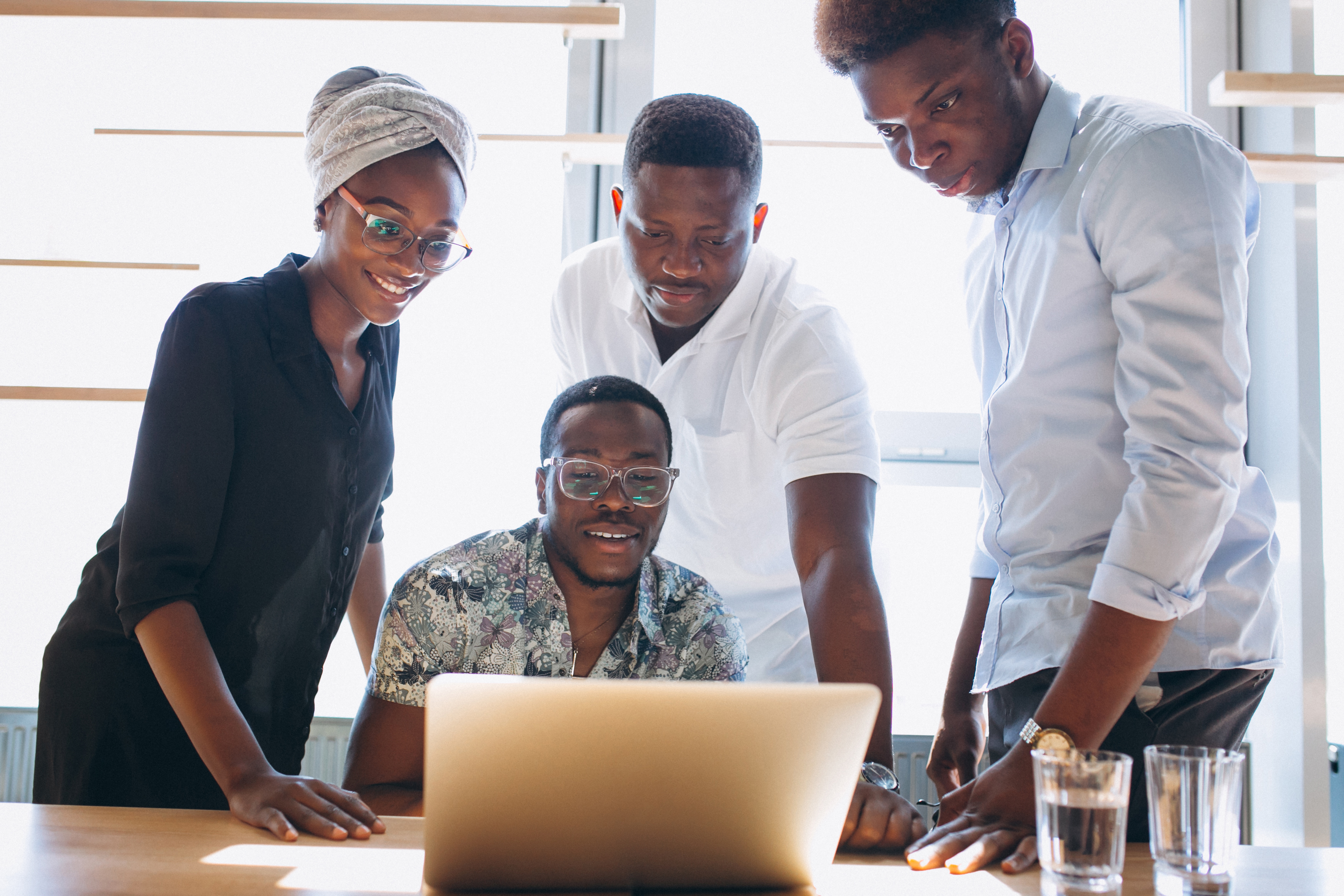 A group of African professionals collaborating in a modern office